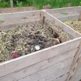 Wooden compost bins filled with soil and garden material